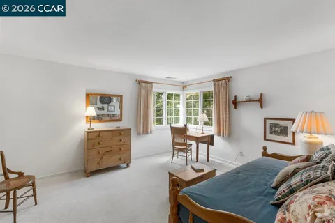 a bedroom with furniture and a window