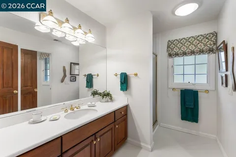 a bathroom with a double vanity sink and a mirror