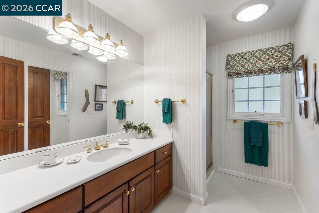 2255 Alameda Diablo Diablo, CA 94528 - Photo 29 of 49 a bathroom with a double vanity sink and a mirror