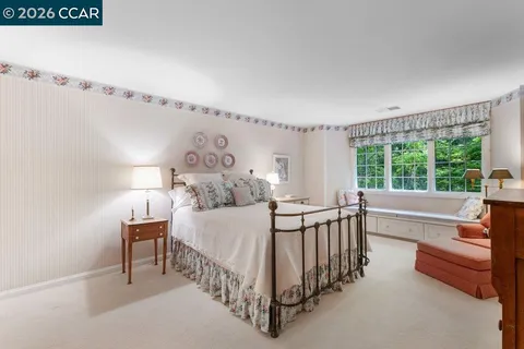 a bed sitting in a bedroom next to a window