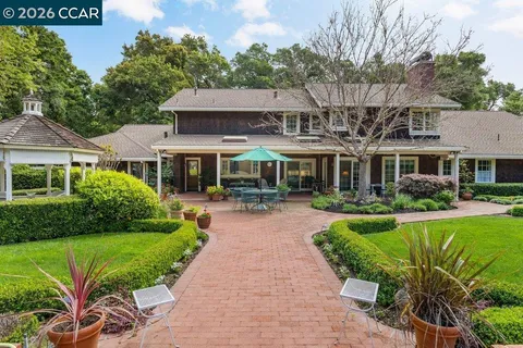 a front view of a house with garden and porch