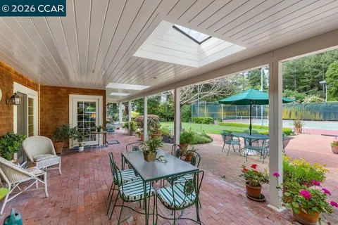a patio with a table and chairs under an umbrella
