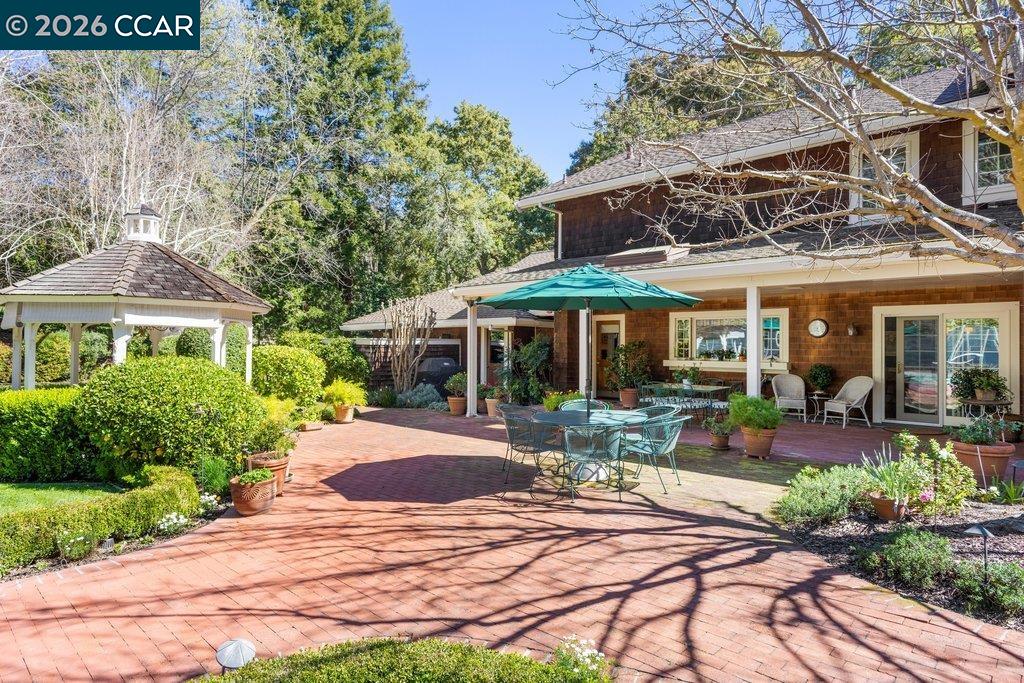 2255 Alameda Diablo Diablo, CA 94528 - Photo 42 of 49 a patio with a table and chairs under an umbrella