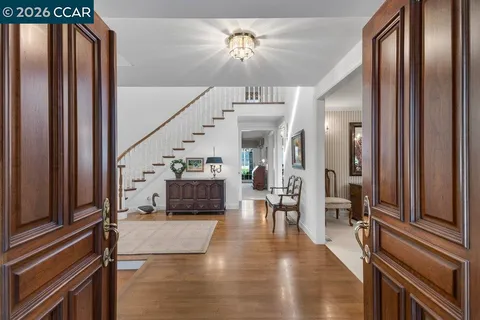 a view of entryway and hall with wooden floor