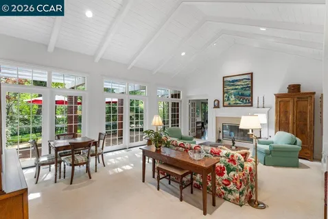 a bedroom with furniture and a large window