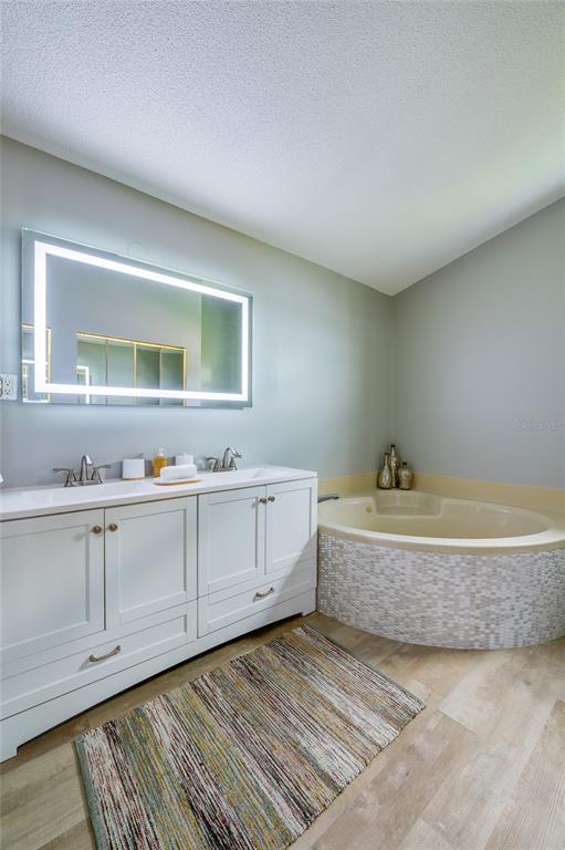 1633 Riverside Drive Daytona Beach, FL 32117 - Photo 19 of 25 a spacious bathroom with a granite countertop sink and a mirror