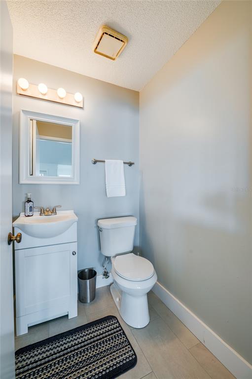 1633 Riverside Drive Daytona Beach, FL 32117 - Photo 9 of 25 a bathroom with a toilet a sink and a mirror