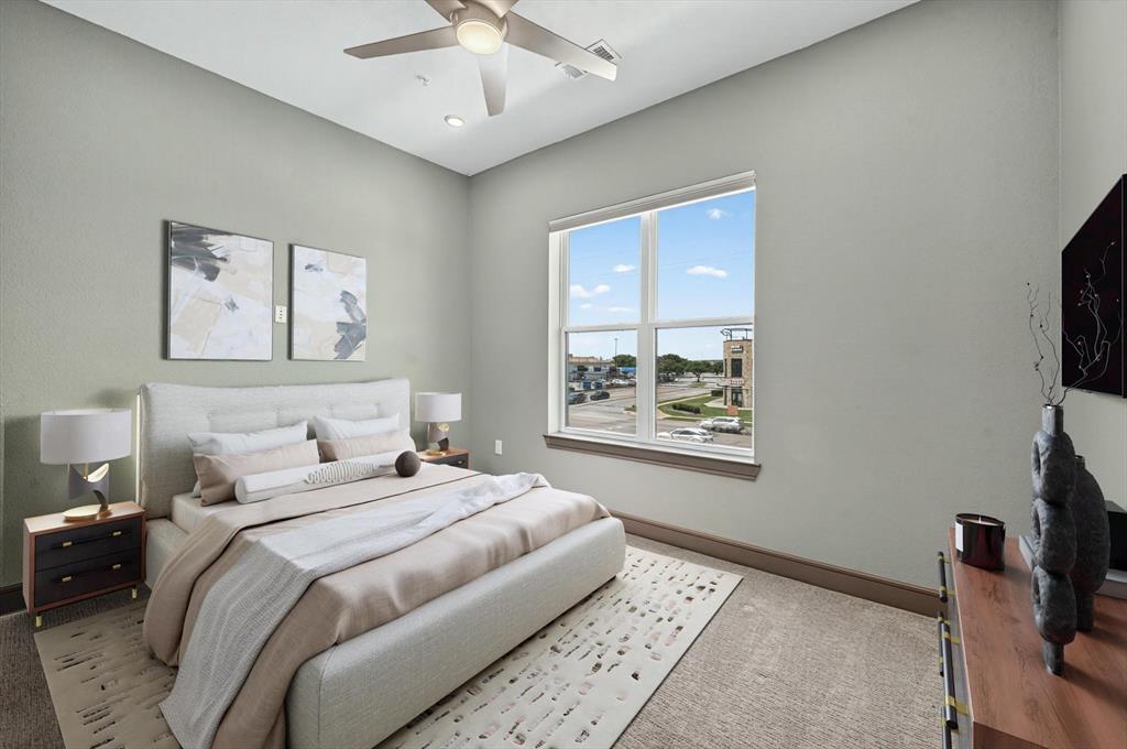 2700 Old Denton Road, Unit 2259 Carrollton, TX 75007 - Photo 6 of 39 a bedroom with a bed and a flat screen tv