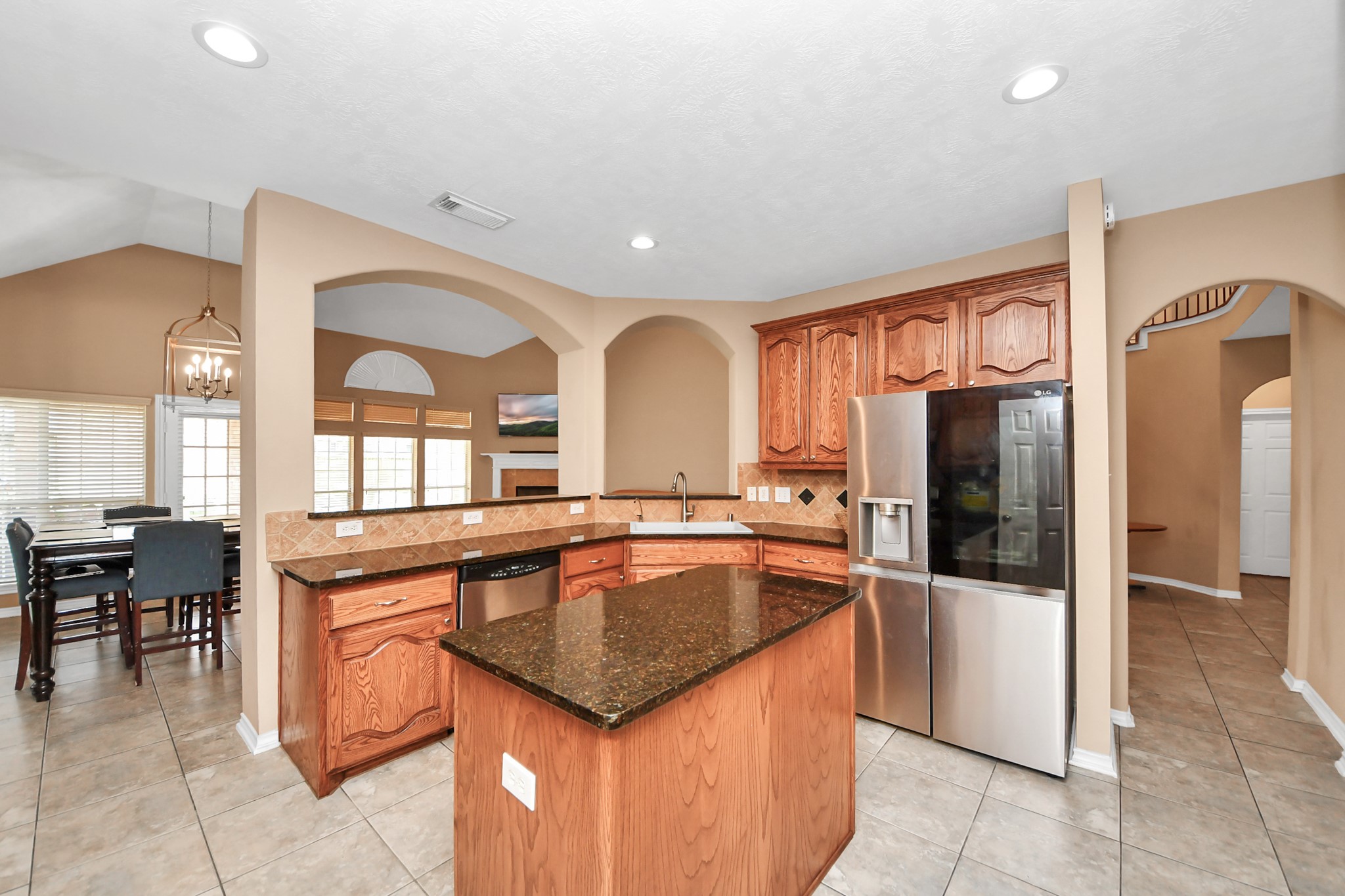 706 River Delta Lane Rosenberg, TX 77469 - Photo 15 of 50 a kitchen with granite countertop stainless steel appliances a sink counter space counter space and cabinets