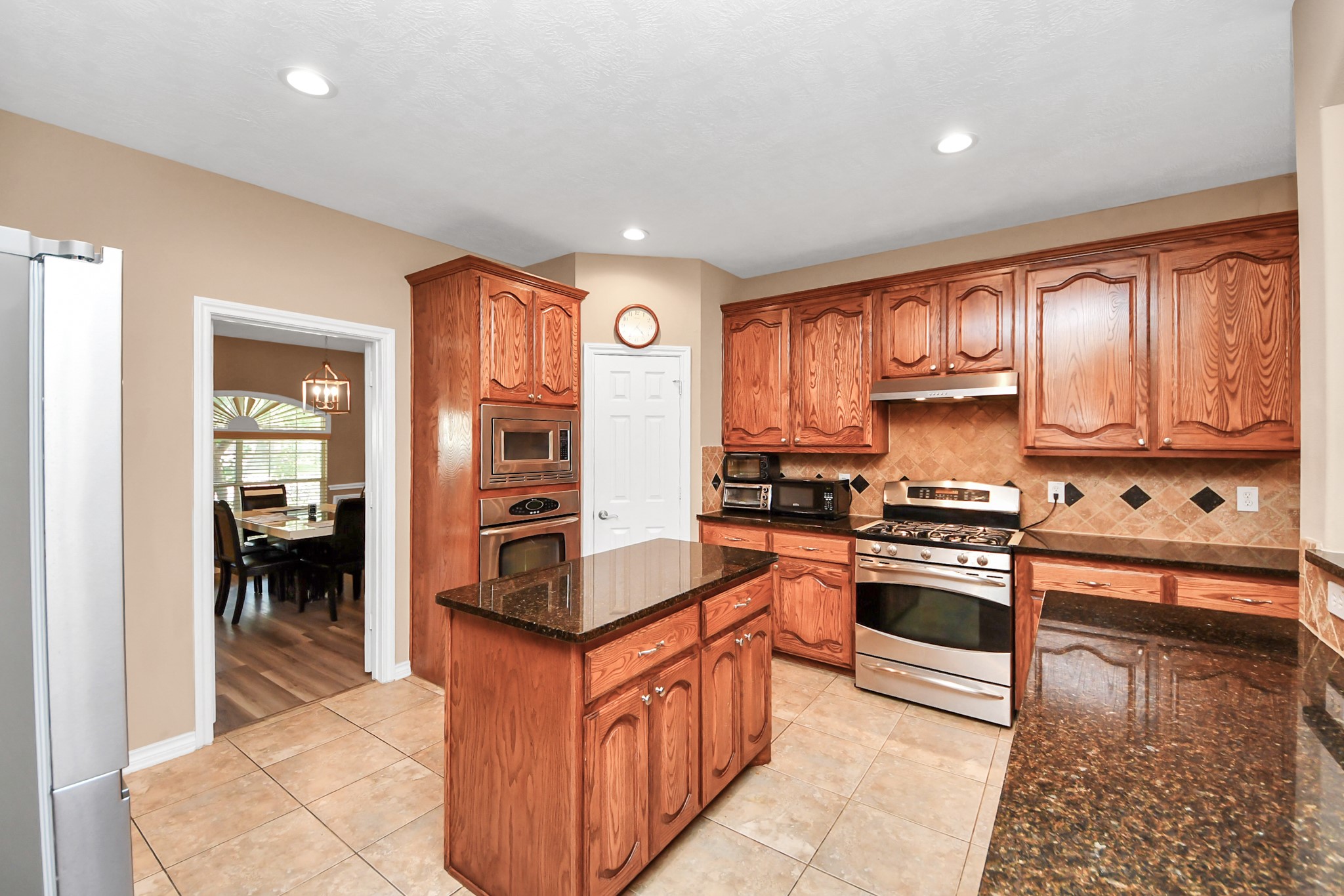 706 River Delta Lane Rosenberg, TX 77469 - Photo 10 of 50 a kitchen with stainless steel appliances granite countertop a stove top oven a sink and dishwasher