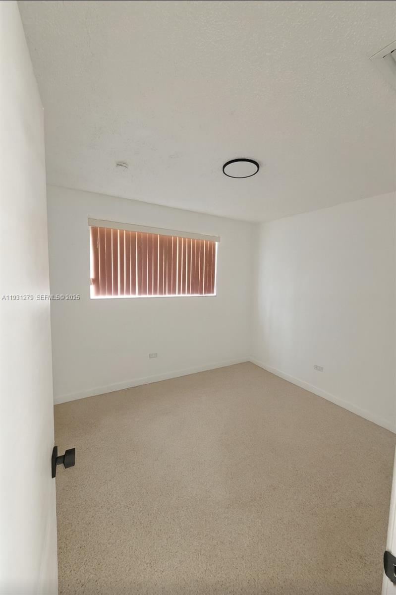 141 West 31st Street Hialeah, FL 33012 - Photo 4 of 9 an empty room with a window