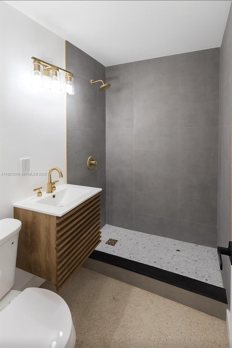 141 West 31st Street Hialeah, FL 33012 - Photo 5 of 9 a bathroom with a sink a toilet and shower