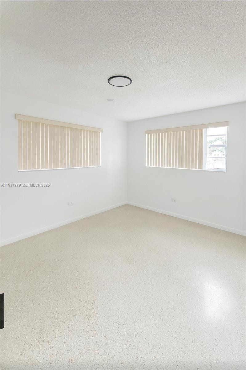 141 West 31st Street Hialeah, FL 33012 - Photo 6 of 9 an empty room with windows
