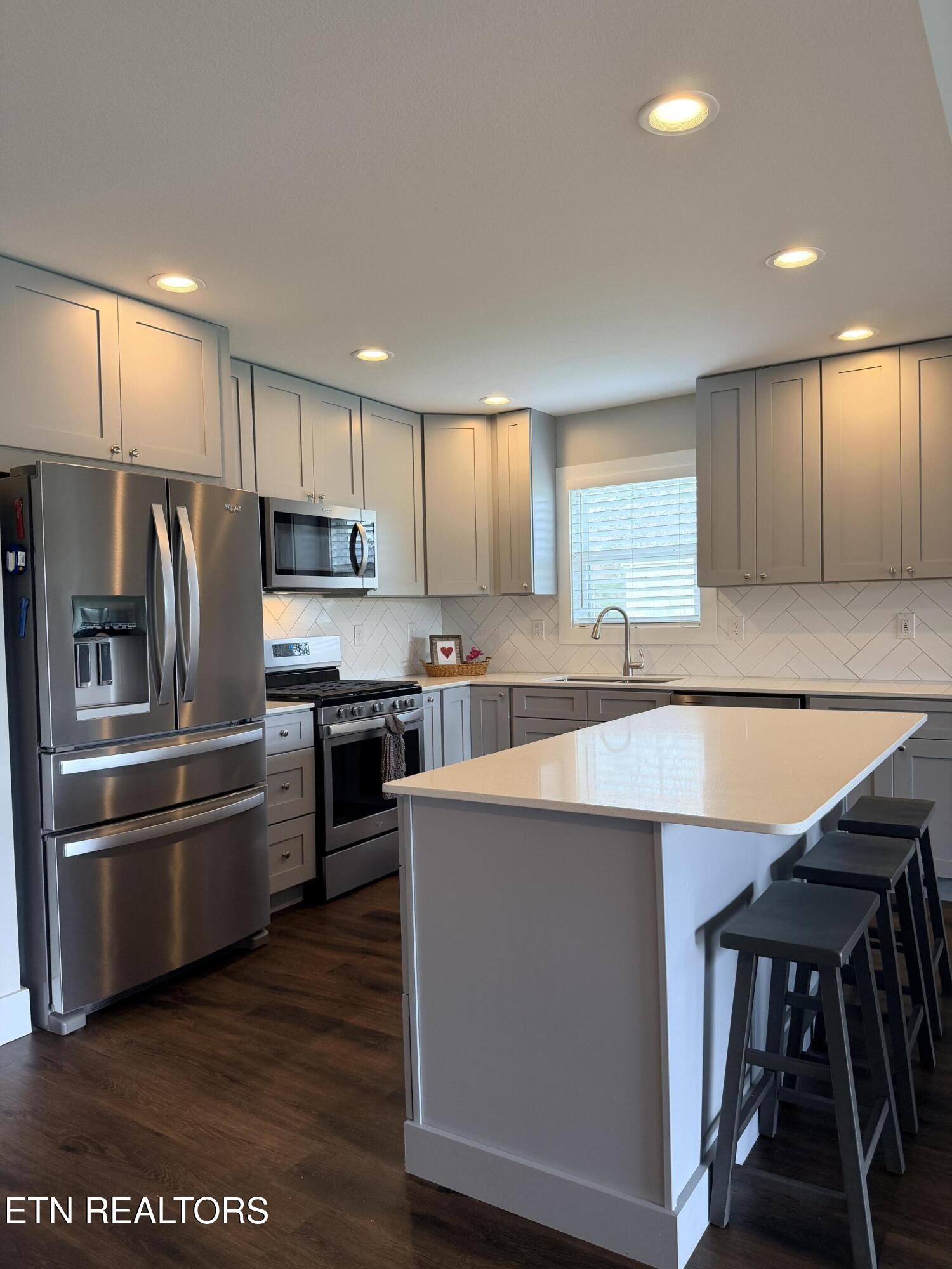 1021 Pleasant Grove Road Winfield, TN 37892 - Photo 25 of 42 a kitchen with kitchen island a stove a refrigerator and a sink