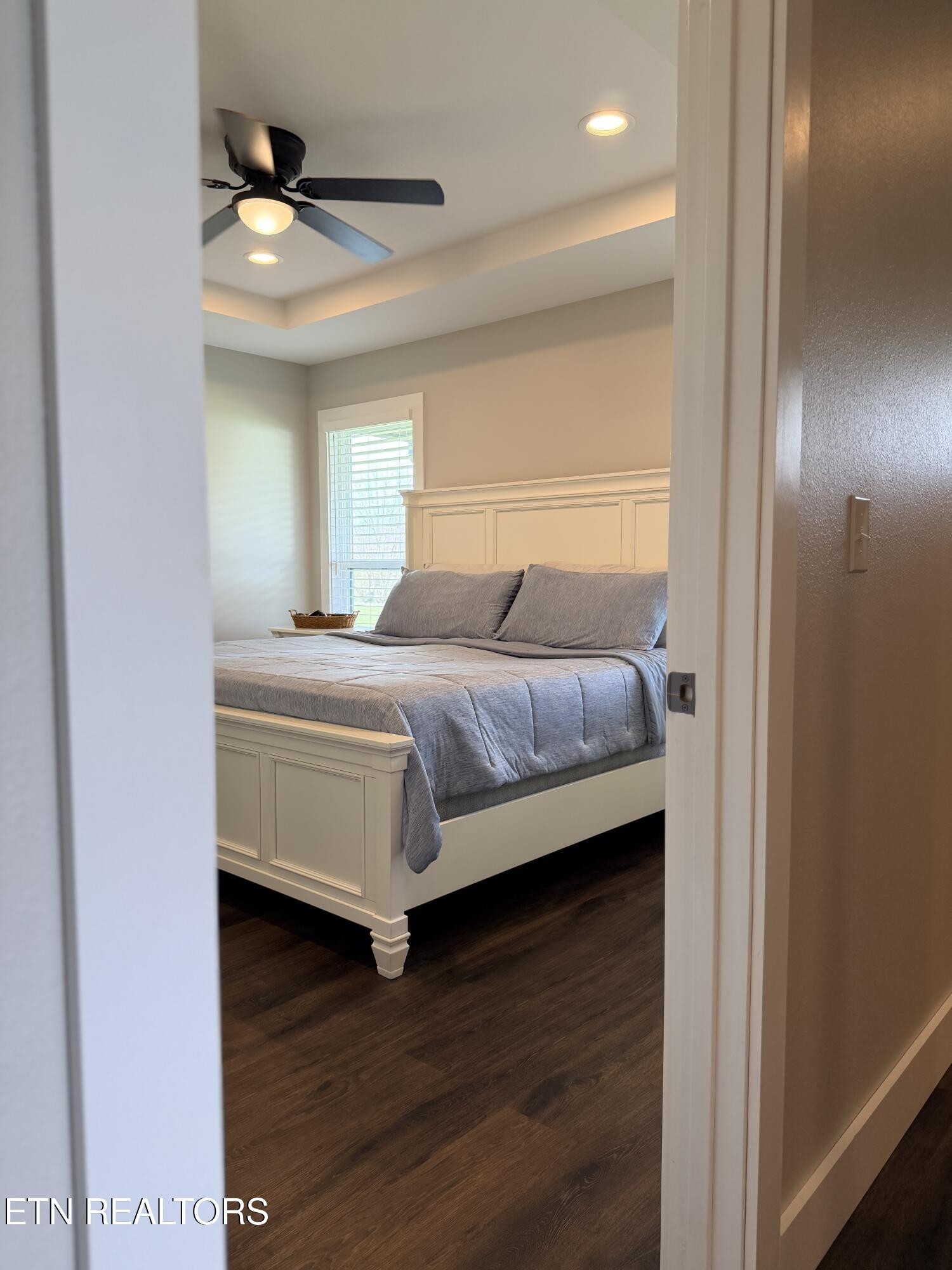 1021 Pleasant Grove Road Winfield, TN 37892 - Photo 29 of 42 a bedroom with a bed and a chandelier