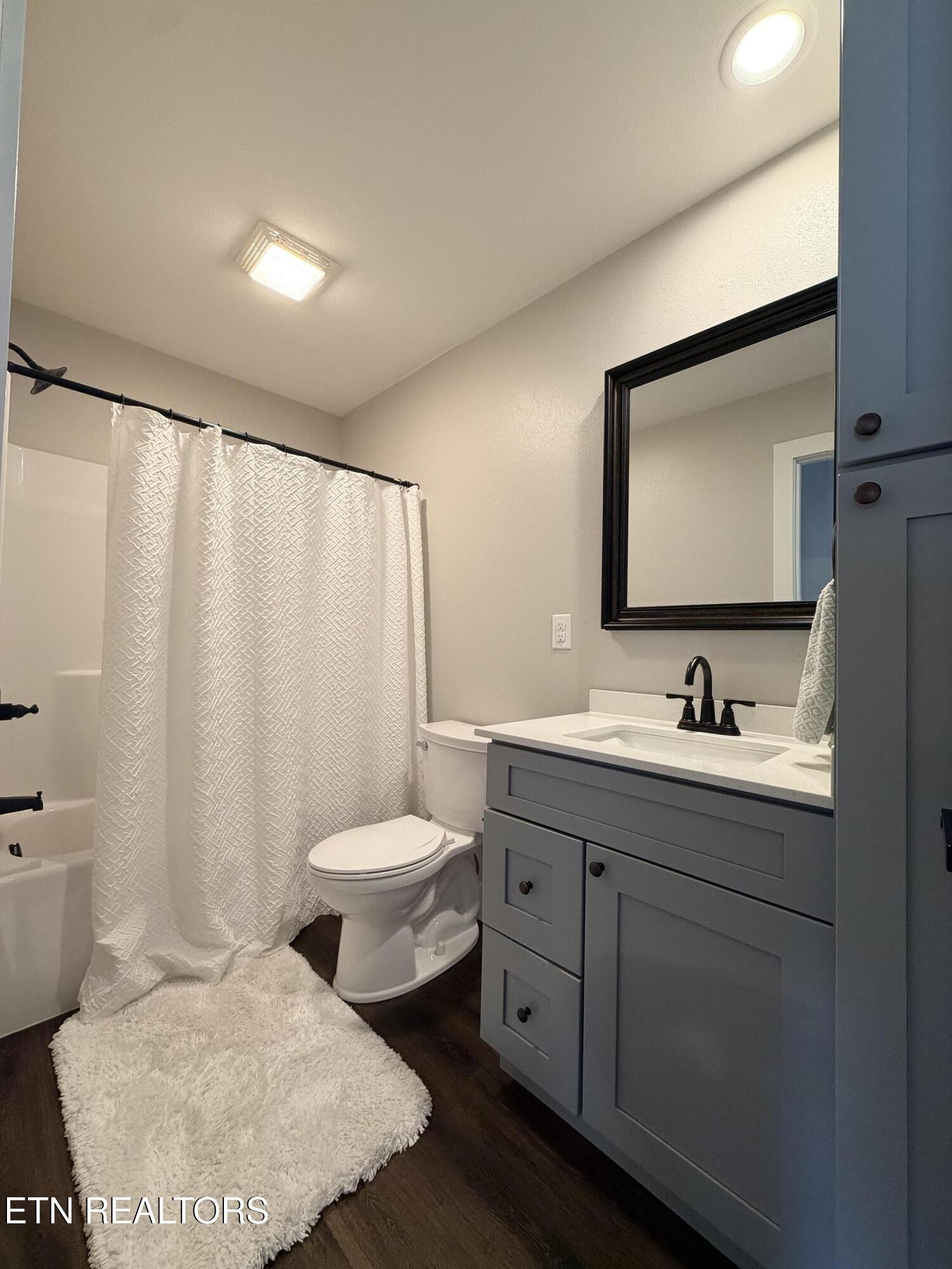 1021 Pleasant Grove Road Winfield, TN 37892 - Photo 37 of 42 a bathroom with a granite countertop sink mirror vanity and toilet