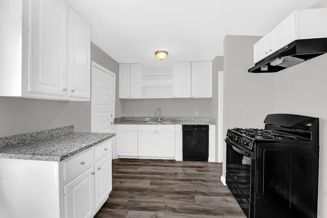 a kitchen with stainless steel appliances granite countertop a stove and a granite counter tops