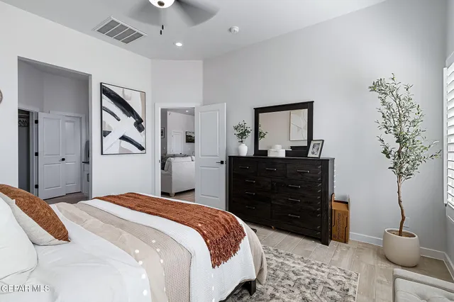 a bedroom with a bed and a potted plant