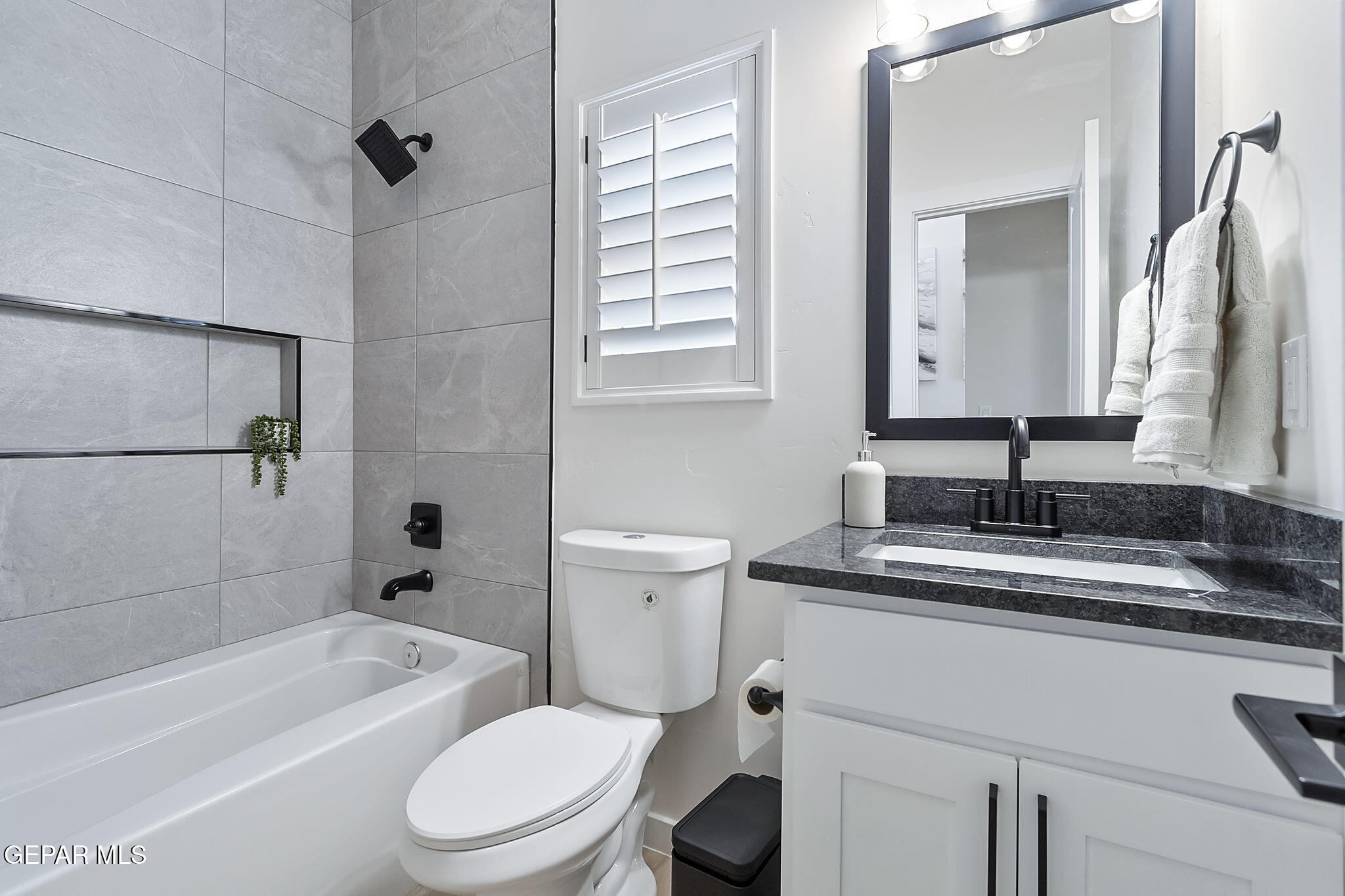 3861 Object Place El Paso, TX 79938 - Photo 7 of 17 a bathroom with a granite countertop sink toilet mirror and bathtub