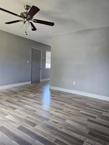 a view of an empty room and wooden floor