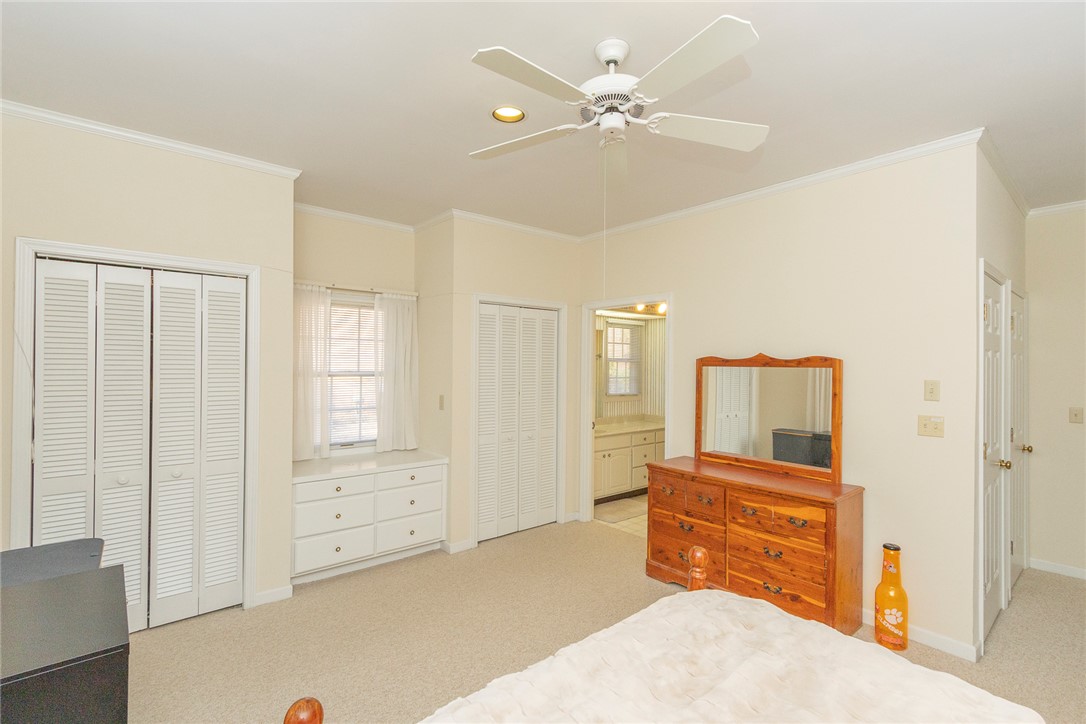 52 Hickory Way Clemson, SC 29631 - Photo 22 of 49 This spacious bedroom offers comfortable living with carpeted floors and a functional ceiling fan.