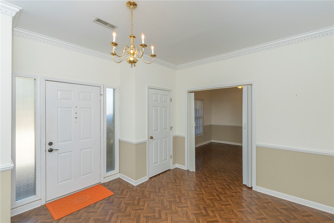 52 Hickory Way Clemson, SC 29631 - Photo 3 of 49 The inviting entryway features durable wood flooring and elegant crown molding.