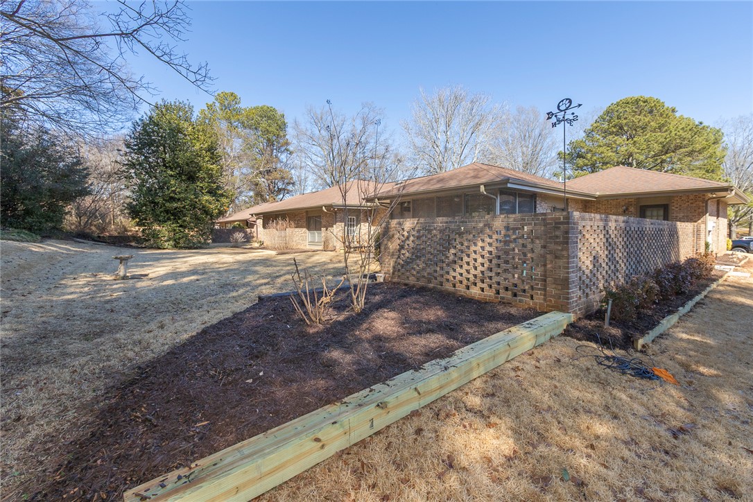 52 Hickory Way Clemson, SC 29631 - Photo 32 of 49 This property features a charming brick exterior with a lush, expansive yard.