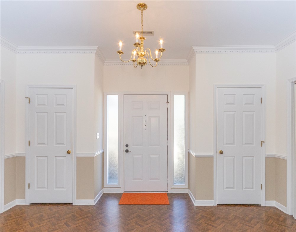 52 Hickory Way Clemson, SC 29631 - Photo 4 of 49 This inviting entrance features crown molding and warm flooring, creating a welcoming first impression.