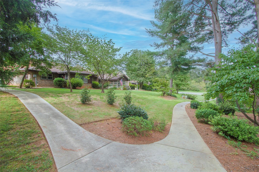 52 Hickory Way Clemson, SC 29631 - Photo 42 of 49 This charming home features a well-manicured lawn and a tranquil natural setting.