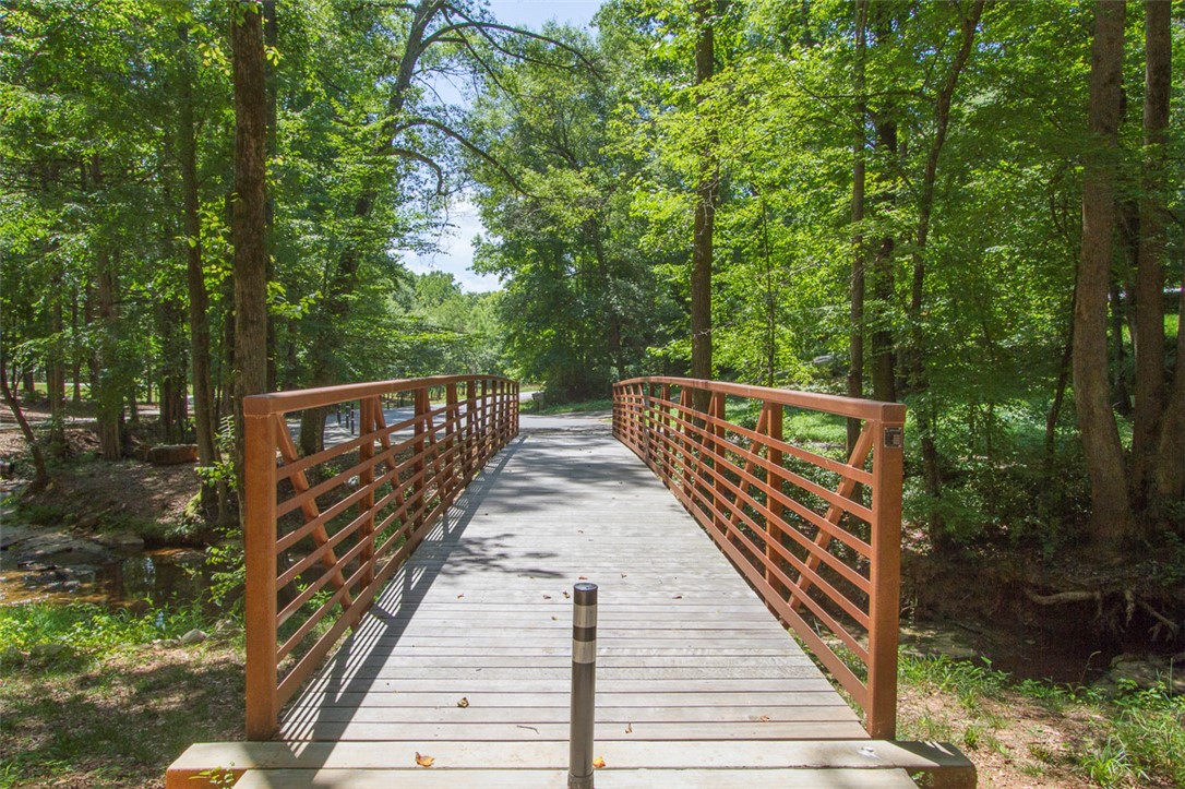 52 Hickory Way Clemson, SC 29631 - Photo 49 of 49 A charming footbridge invites tranquil strolls amidst lush greenery and serene natural surroundings.