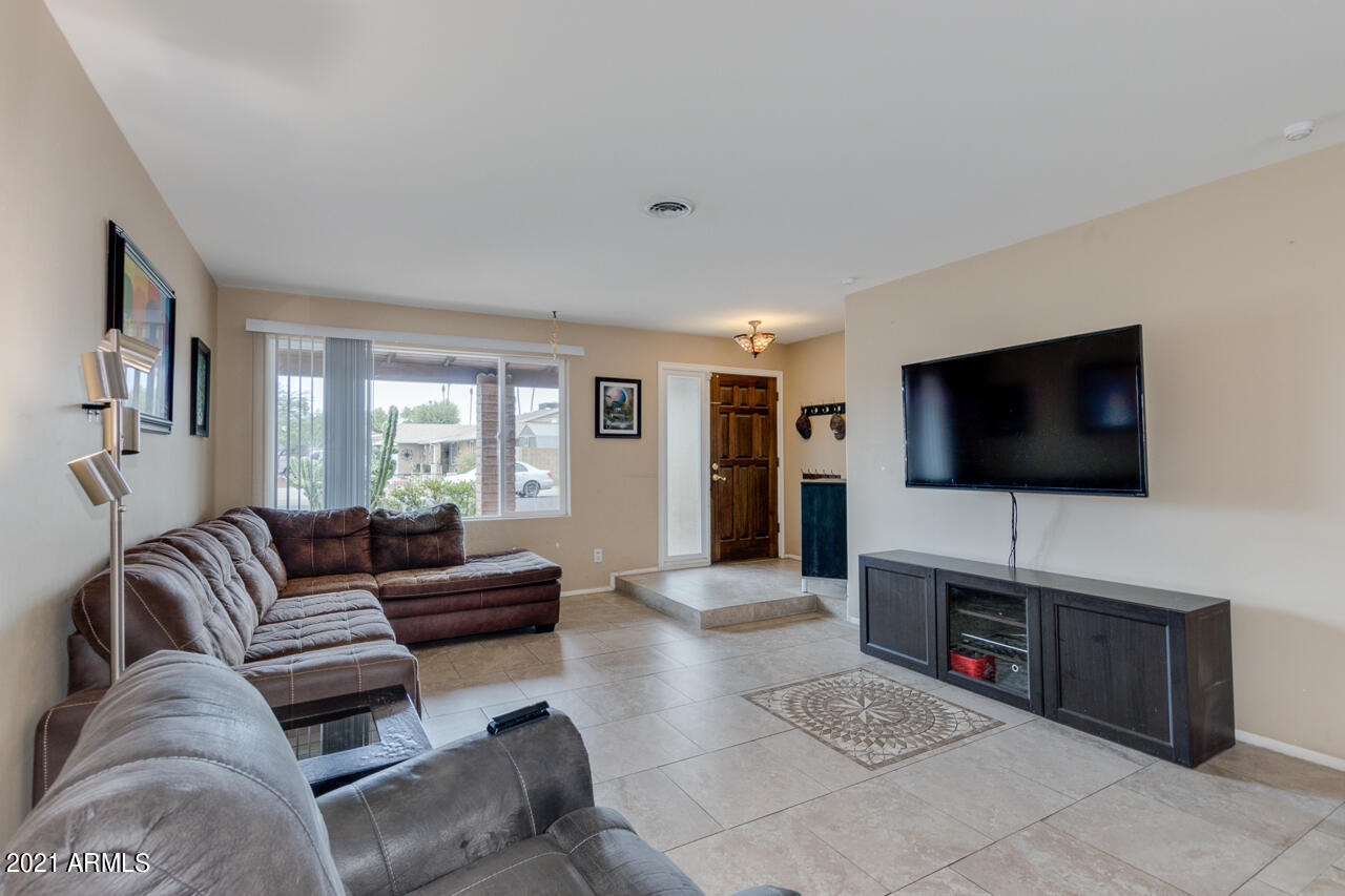 4215 West Dailey Street Phoenix, AZ 85053 - Photo 8 of 32 a living room with furniture and a flat screen tv