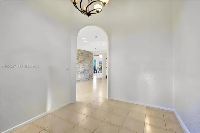 an empty room with a ceiling fan and carpet