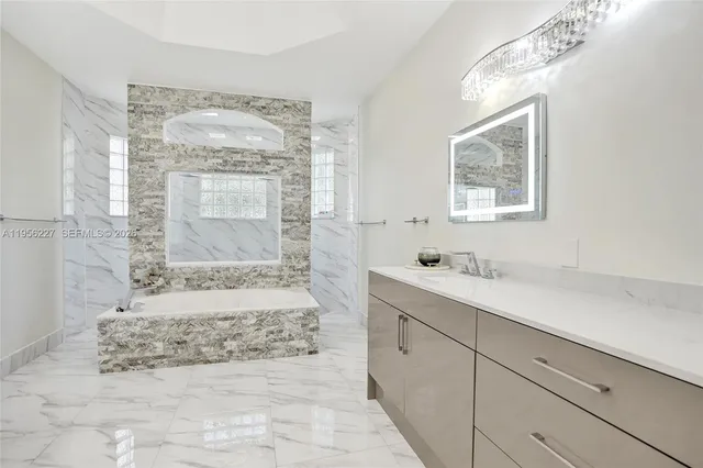 a kitchen with stainless steel appliances granite countertop a refrigerator sink and stove