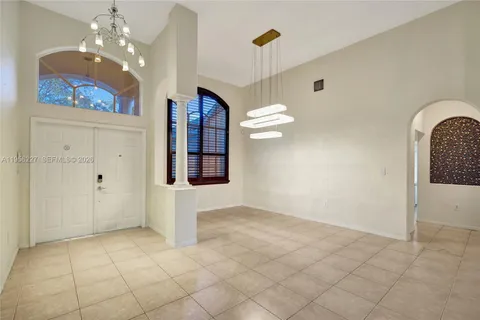 a view of a dining room with furniture and chandelier