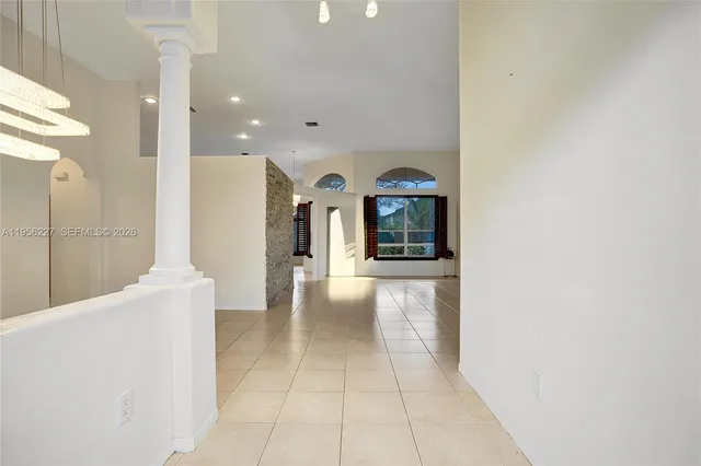 a view of an empty room with glass door