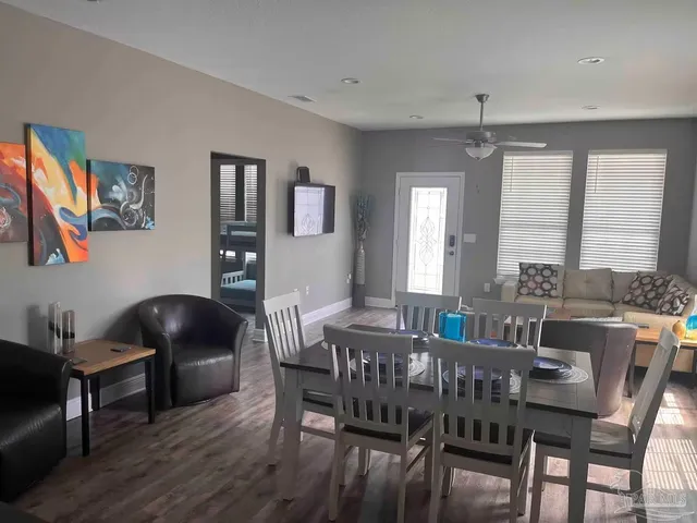 a view of a dining room with furniture and wooden floor