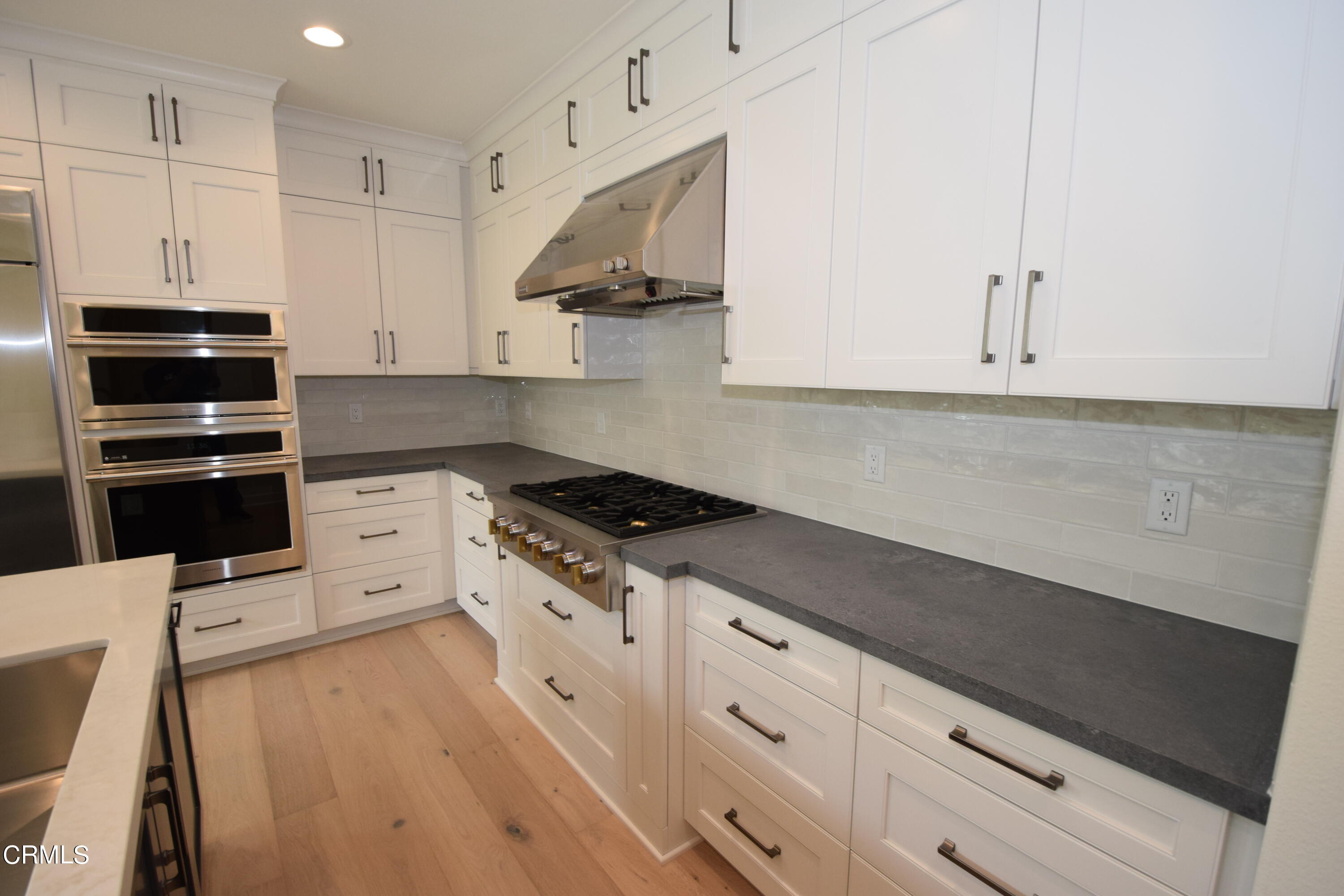 2480 Rondell Road Camarillo, CA 93012 - Photo 18 of 52 a kitchen with granite countertop a stove a sink and a refrigerator