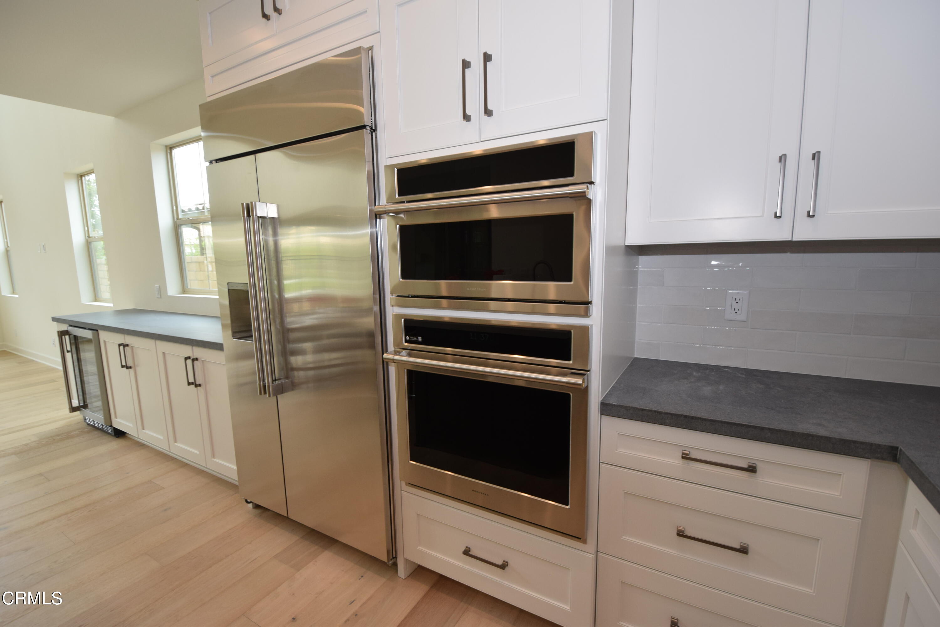 2480 Rondell Road Camarillo, CA 93012 - Photo 21 of 52 a kitchen with granite countertop white cabinets and stainless steel appliances