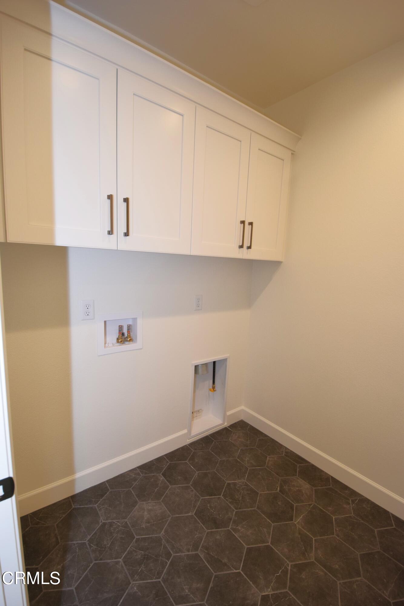 2480 Rondell Road Camarillo, CA 93012 - Photo 25 of 52 a view of a kitchen with white cabinets and a sink