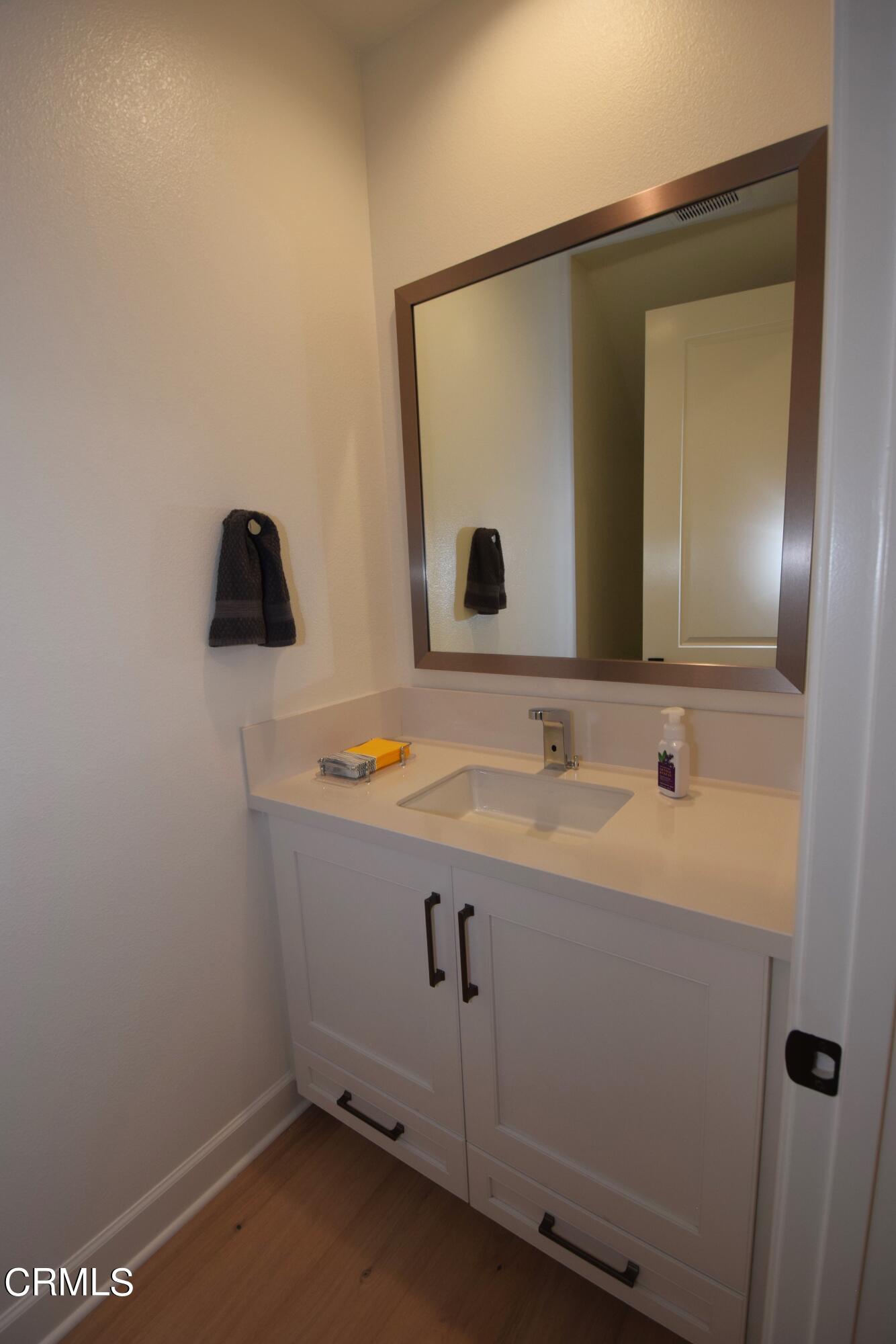 2480 Rondell Road Camarillo, CA 93012 - Photo 28 of 52 a bathroom with a sink and a mirror