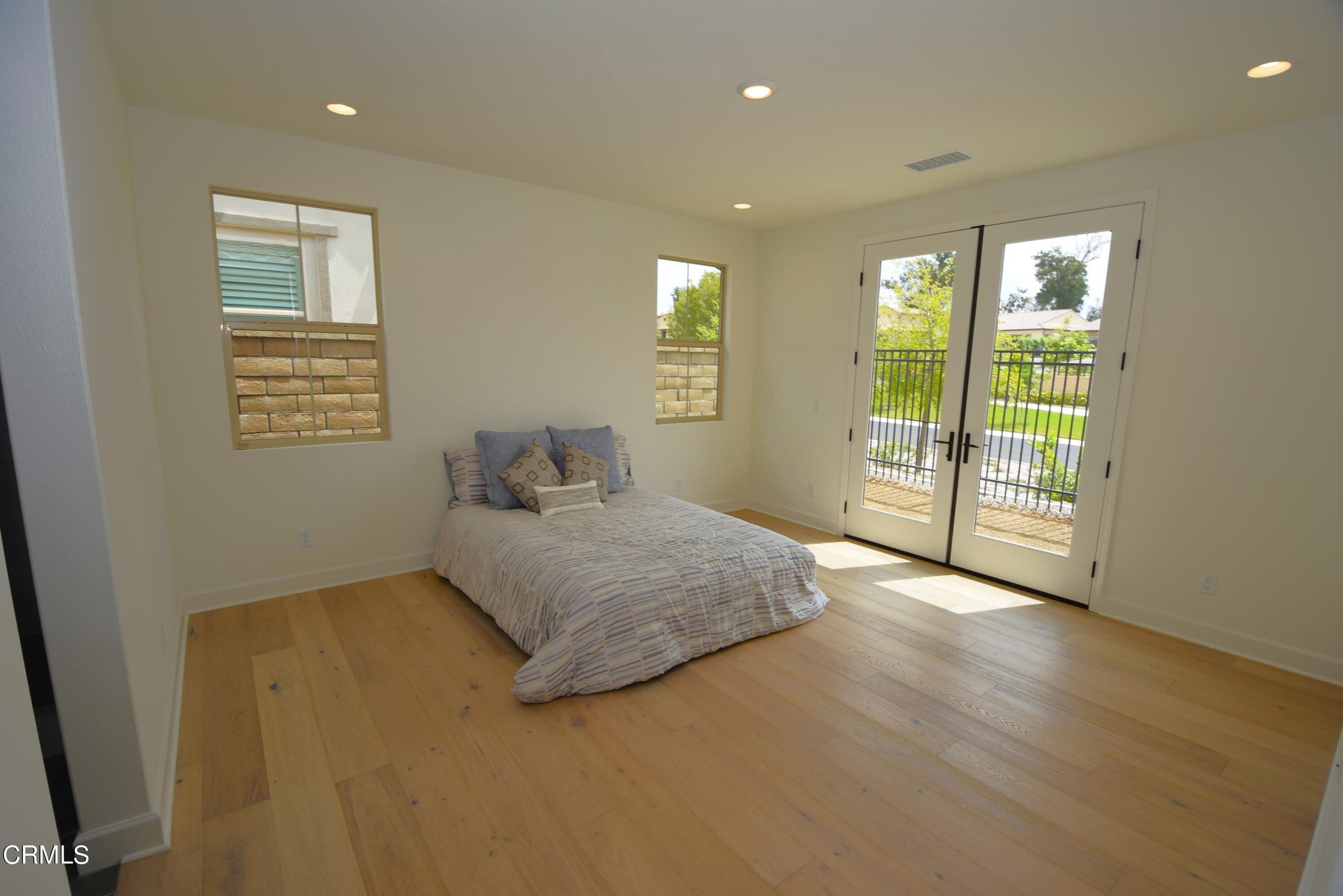 2480 Rondell Road Camarillo, CA 93012 - Photo 3 of 52 a spacious bedroom with a balcony a bed and a dresser