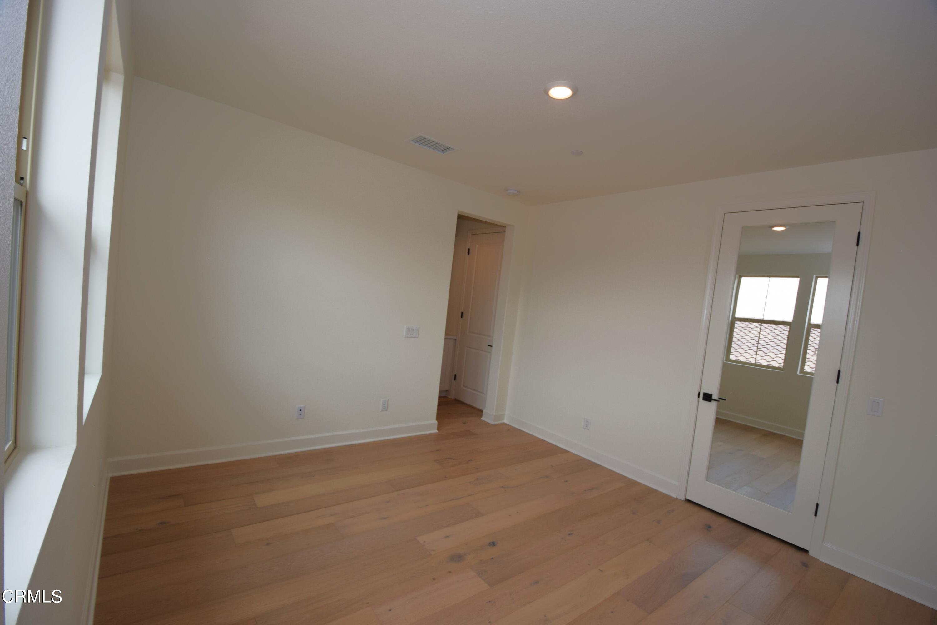 2480 Rondell Road Camarillo, CA 93012 - Photo 32 of 52 an empty room with wooden floor and windows