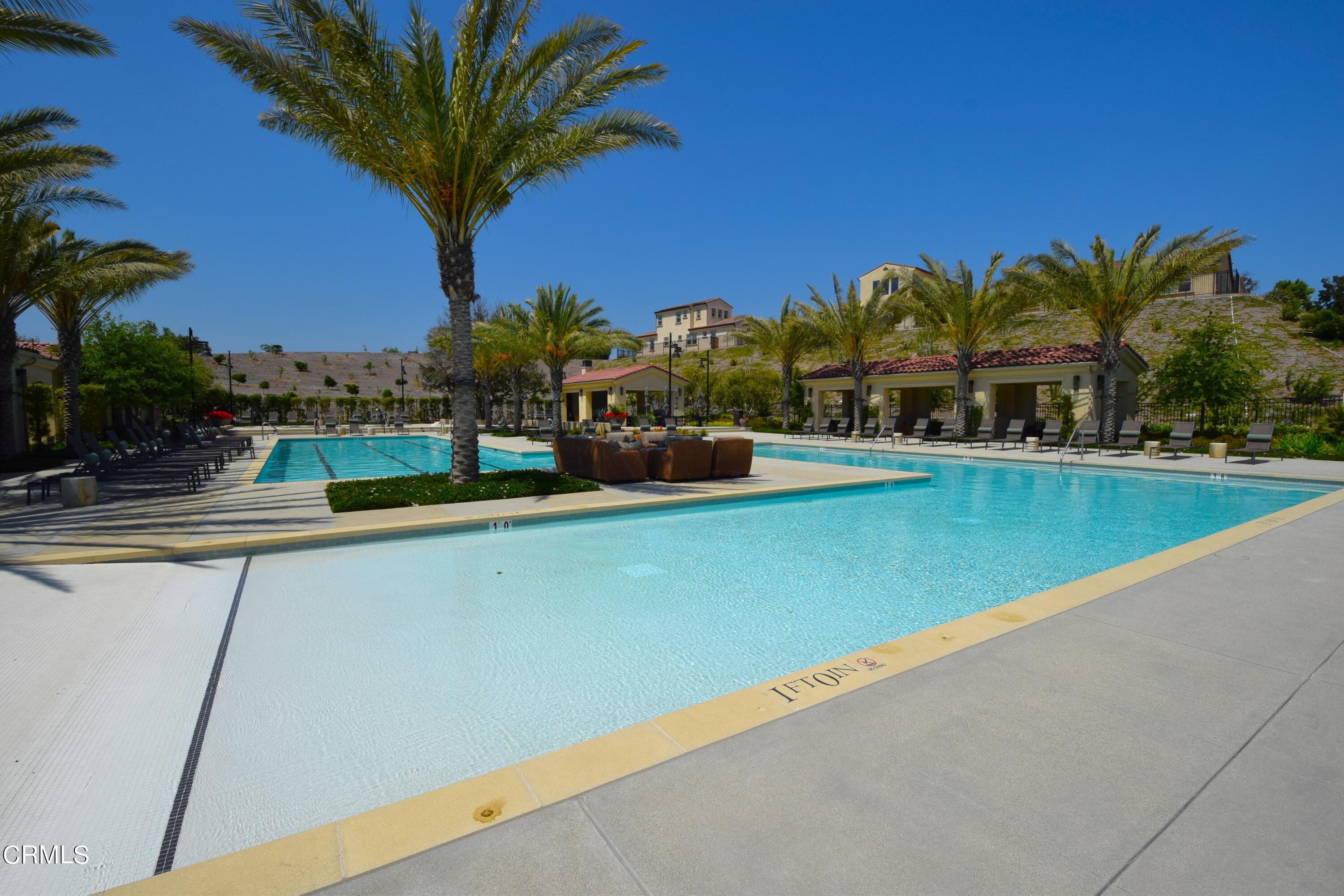 2480 Rondell Road Camarillo, CA 93012 - Photo 45 of 52 a view of a swimming pool with a lawn chairs under an umbrella