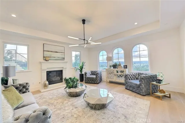 a large kitchen with stainless steel appliances kitchen island a large counter top a stove a chimney a sink and a large window