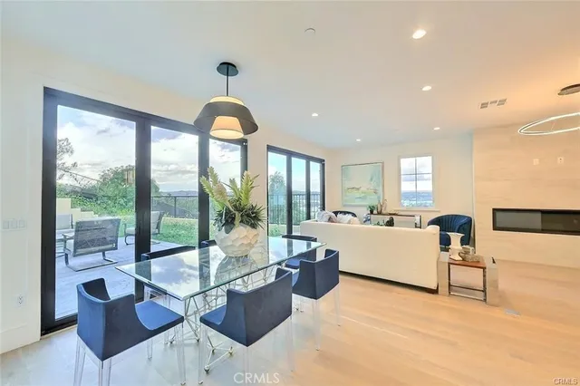 an aerial view of residential houses with outdoor space and trees