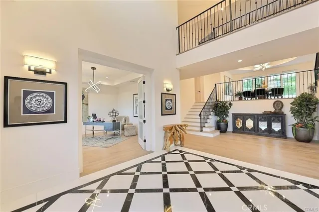 a living room with furniture a fireplace and a chandelier