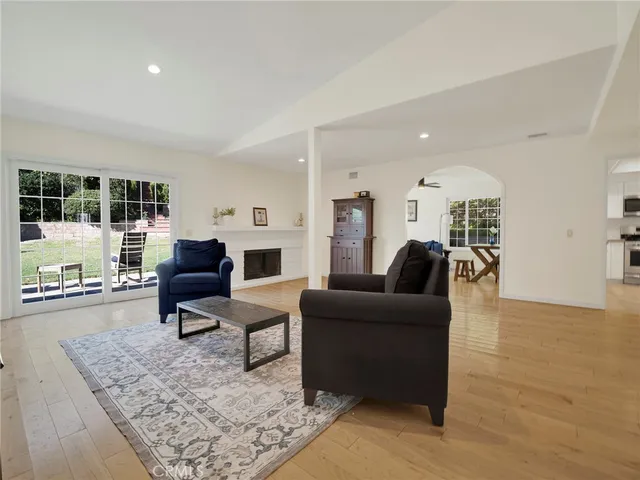 a kitchen with stainless steel appliances granite countertop a stove top oven a sink a microwave and a refrigerator