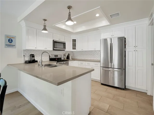 a kitchen with a sink cabinets and stainless steel appliances