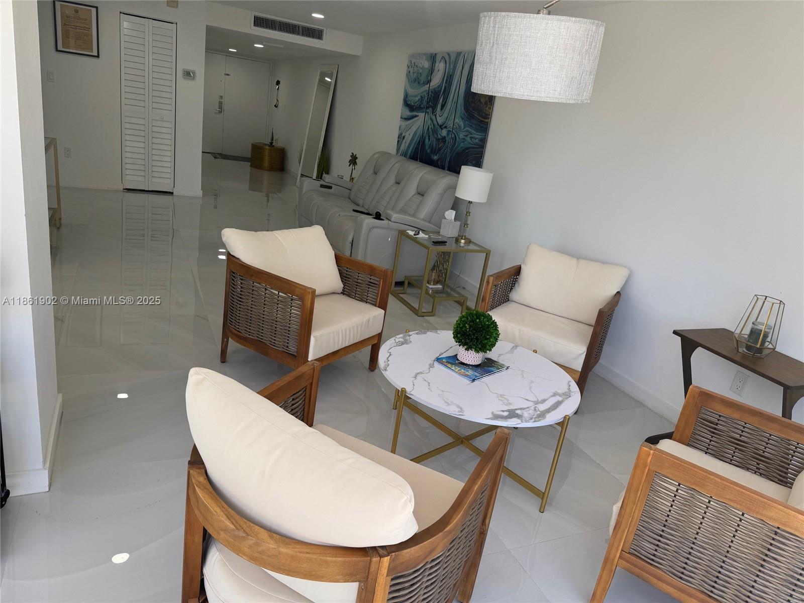 6423 Collins Avenue, Unit 401 Miami Beach, FL 33141 - Photo 11 of 17 a living room with furniture and a wooden floor