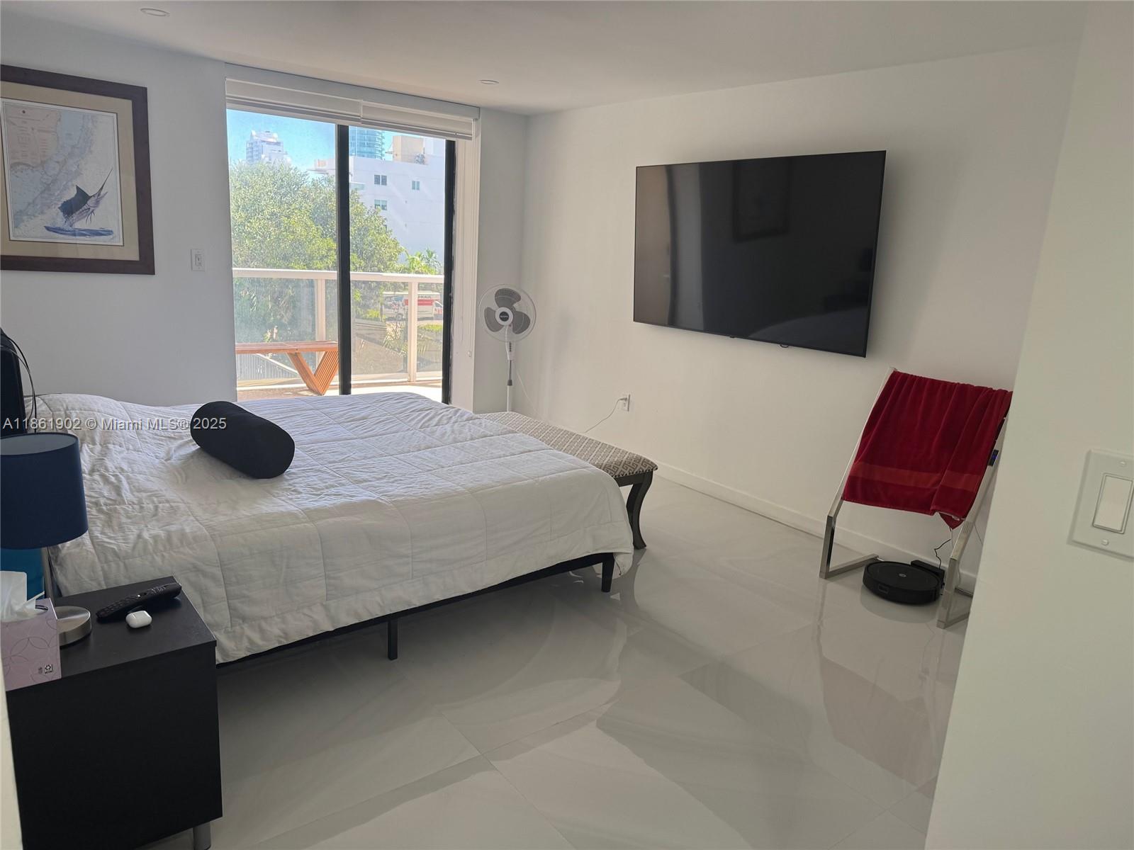 6423 Collins Avenue, Unit 401 Miami Beach, FL 33141 - Photo 14 of 17 a bedroom with a bed and a window